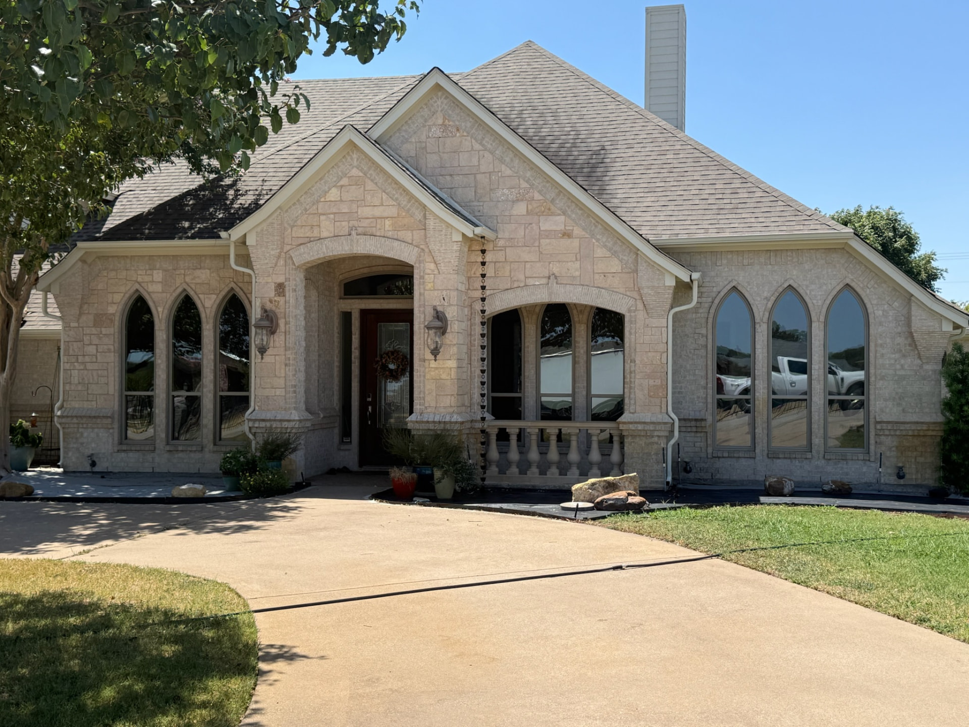 Custom pointed and arched replacement windows fitted to a stone home