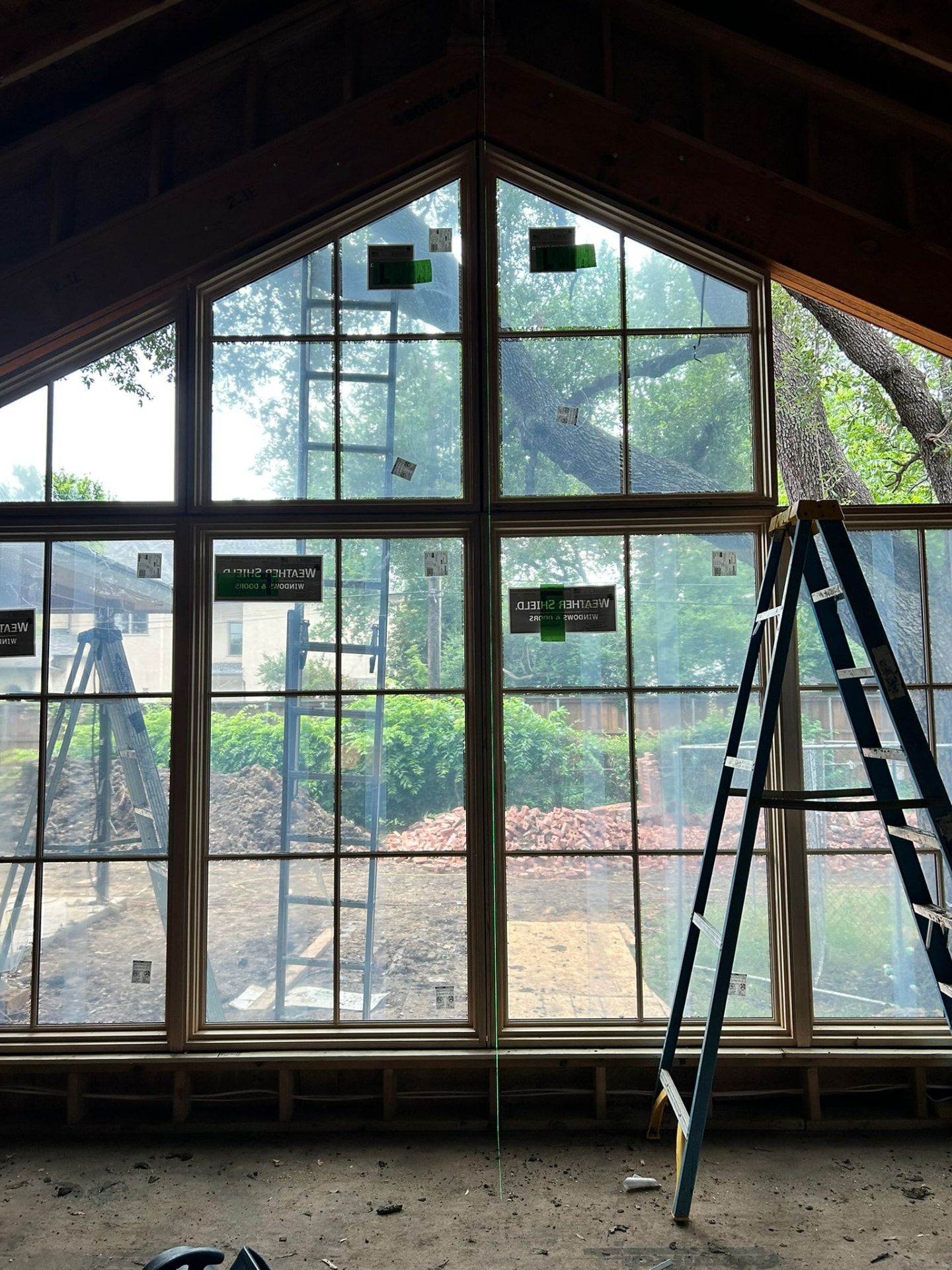 Detail view of a completed angular window wall inside a new build