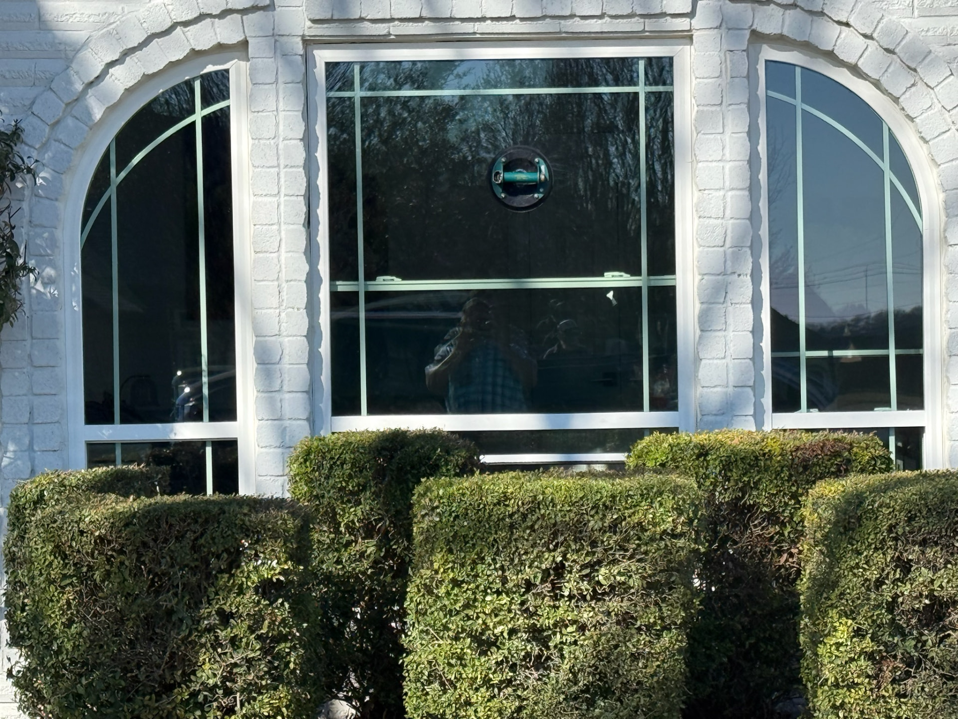 Detailed retrofit installation with arched and rectangular replacement windows
